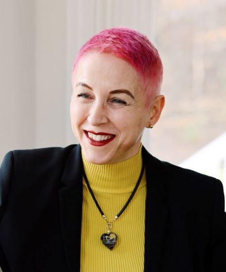 Gabriela Humailo - a smiling pink hair lady